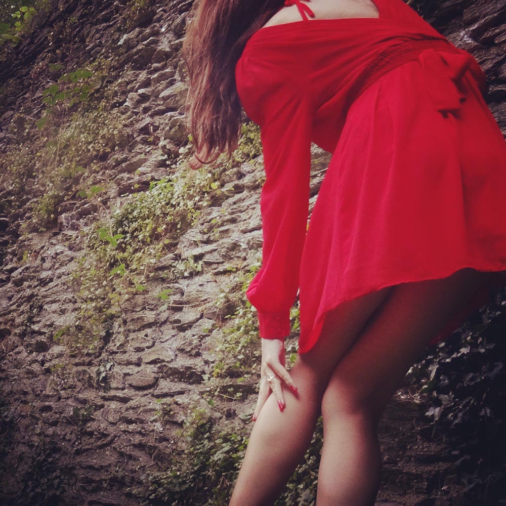 TFNC Red Skater Dress with Chiffon Cross Front and Red Ankle Strap Heels Modelling Photo, by Transgender Model Sophie Lawson